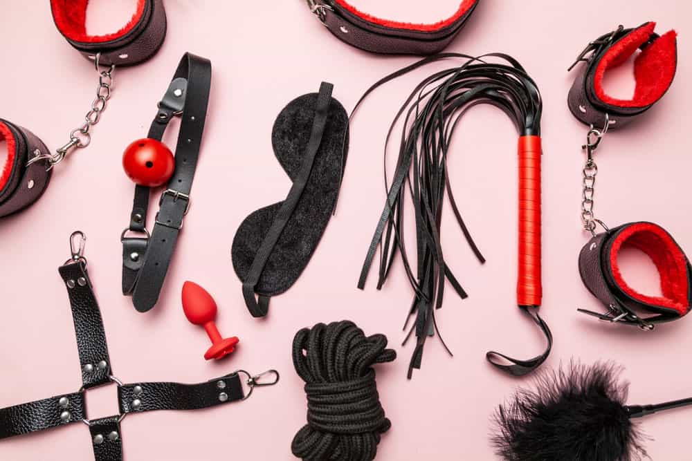 red and black Kinky Toys on a pink background